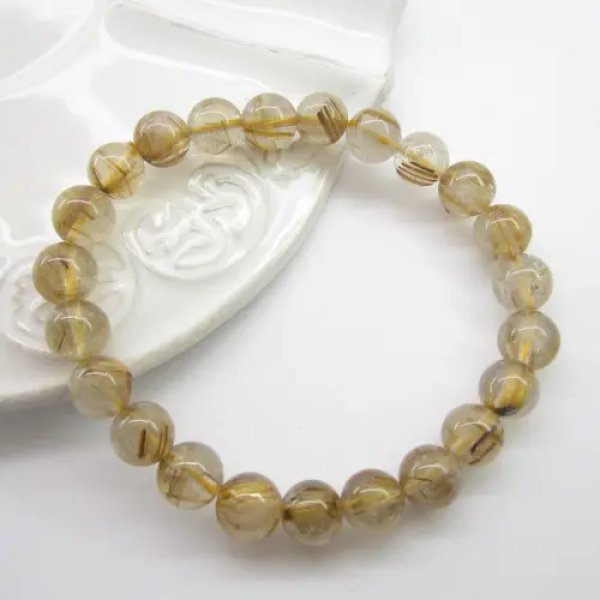 Kwarc Rutylowy ze złotą nitką kulki 7,5-8 mm - bransoleta(sztuka)
