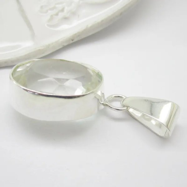 Kryształ Górski fasetowany i srebro - wisiorek owal