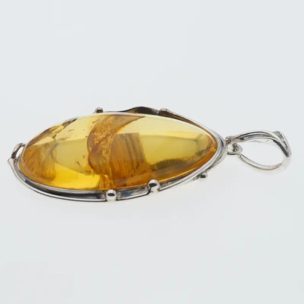 Przezroczysty bursztyn z szczątkami roślinnymi  i srebro oksydowane - wisiorek