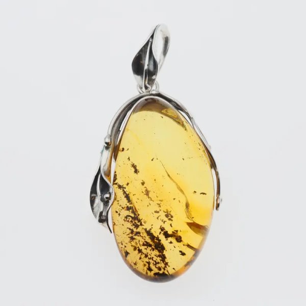Przezroczysty bursztyn z szczątkami organicznymi  i srebro oksydowane - wisiorek