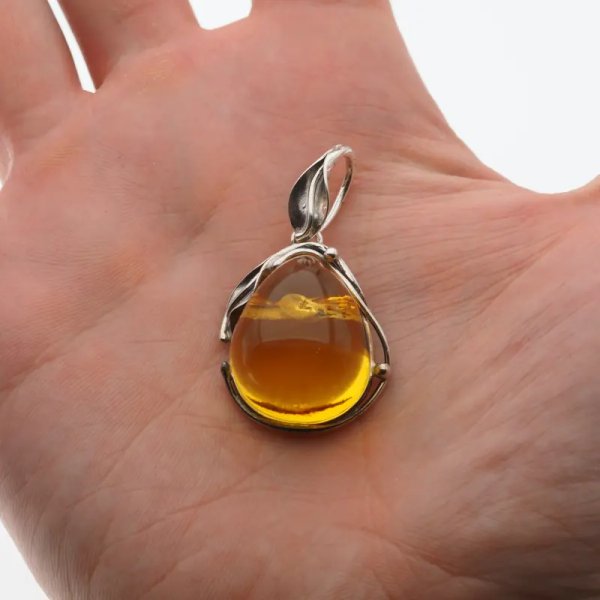 Przezroczysty bursztyn z szczątkami roślinnymi  i srebro oksydowane - wisiorek